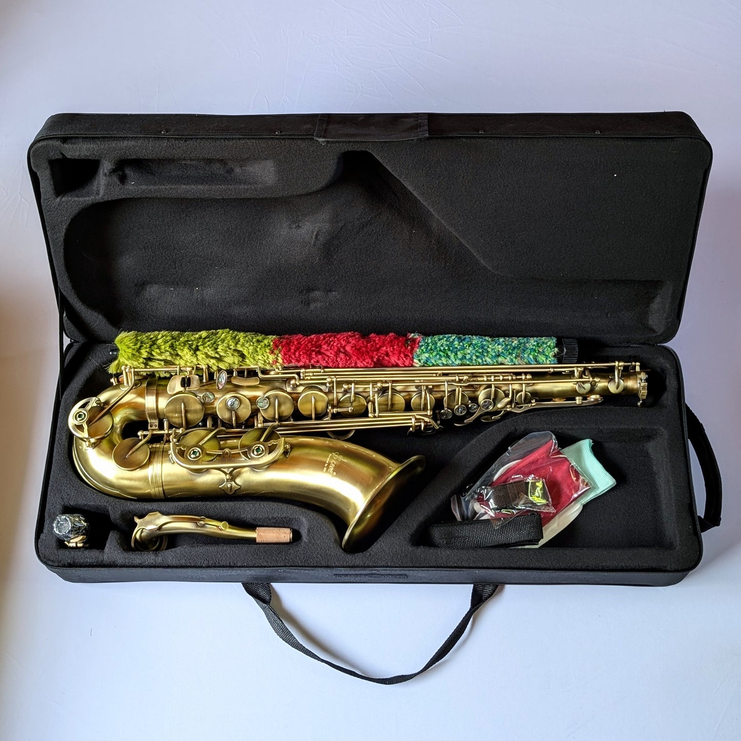 Slade matte brass tenor saxophone with traditional curved body, responsive key action, and reinforced posts for student musicians