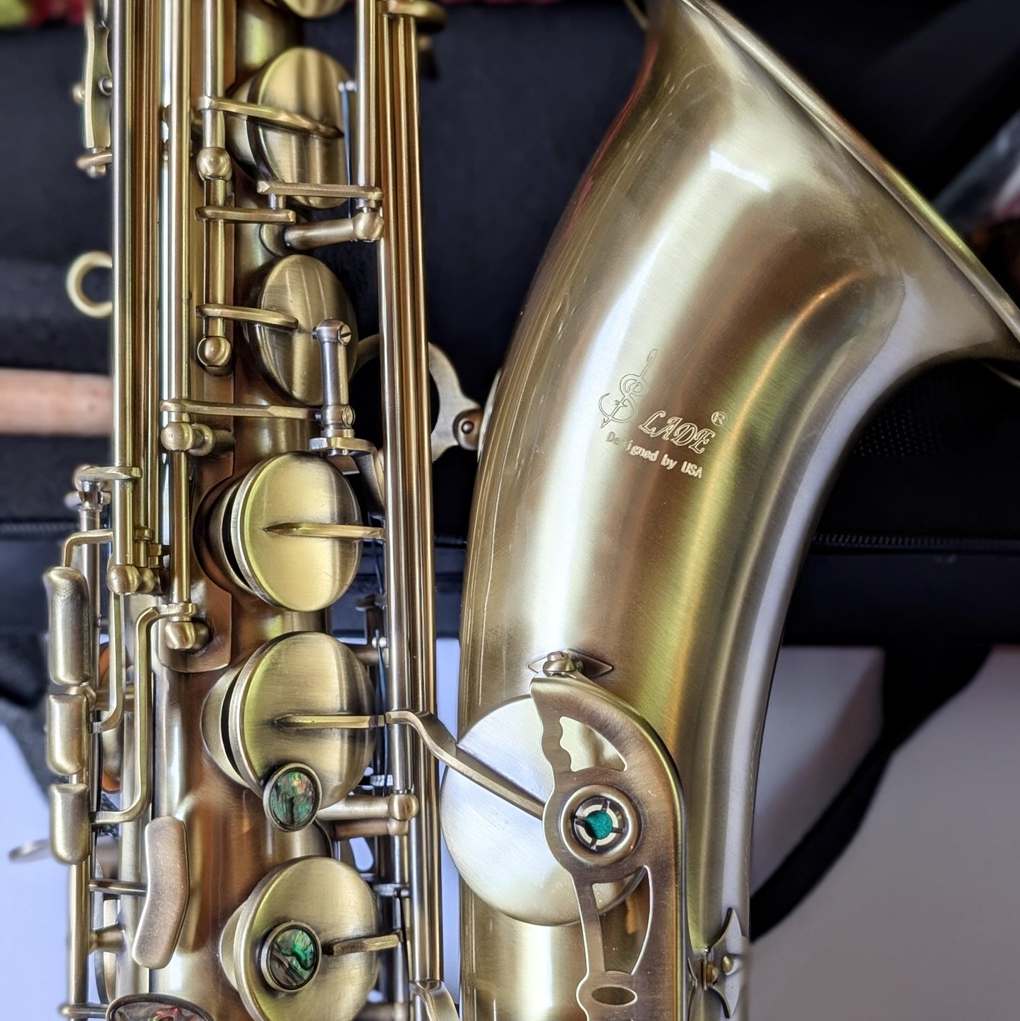 Slade matte brass tenor saxophone with traditional curved body, responsive key action, and reinforced posts for student musicians