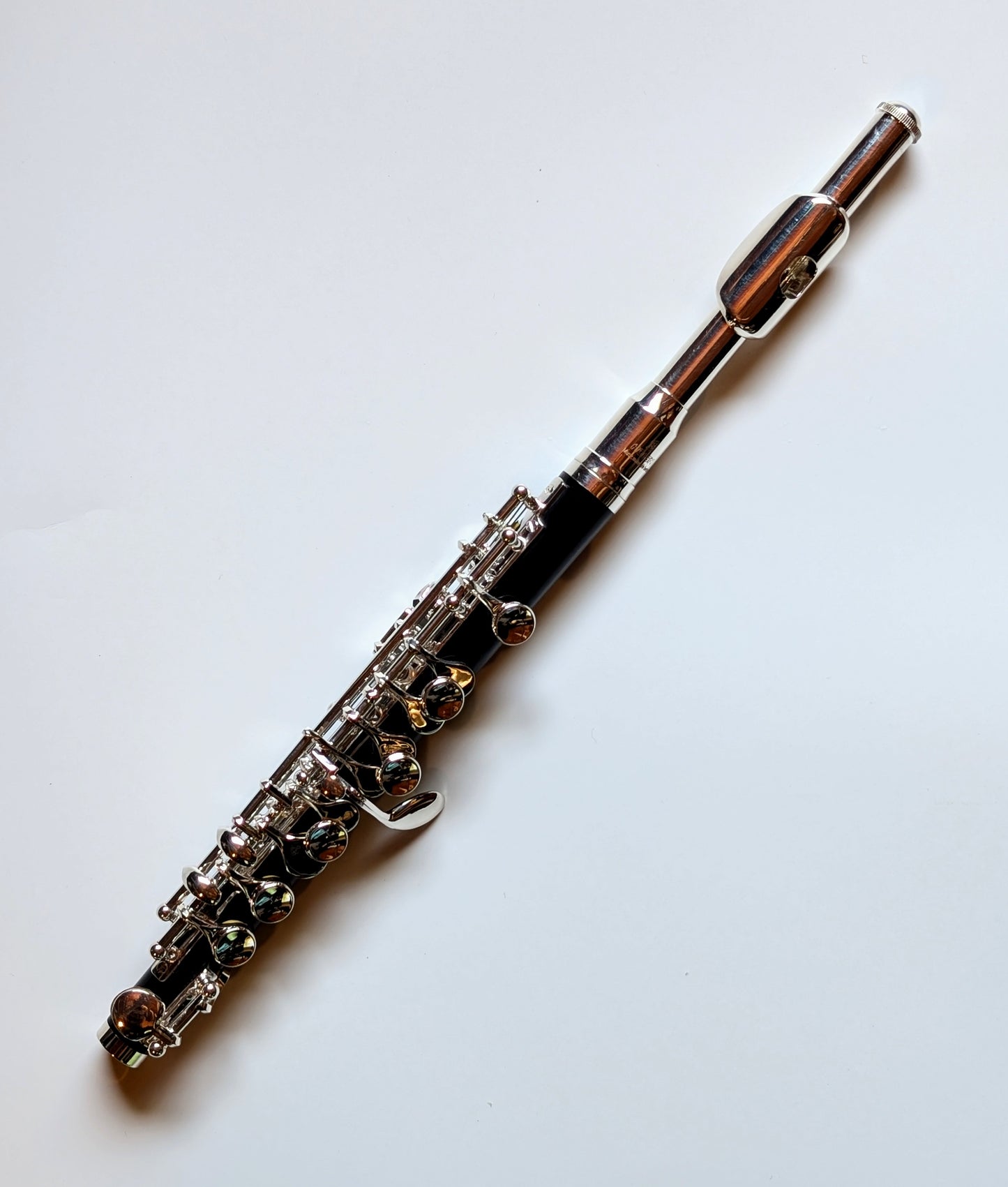 Slade silver-plated headjoint piccolo with black Bakelite body, silver-plated keys and mechanisms for student to intermediate players