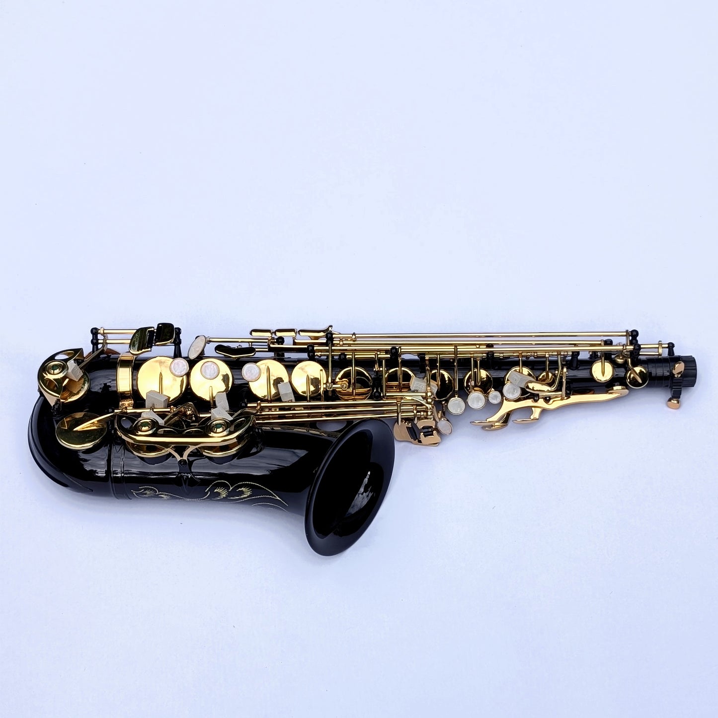 Black lacquered alto saxophone with brass keys and decorative engraving, featuring Premium high F# key for extended range