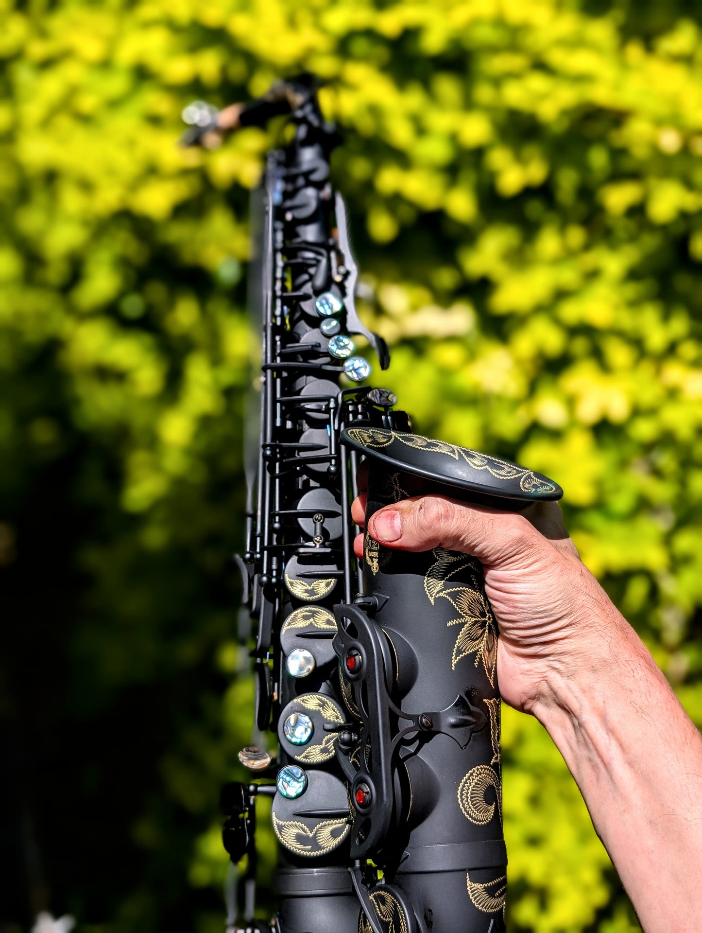 PNW Music matte black alto saxophone with Japanese-inspired finish, featuring high F# key and non-reflective surface for students
