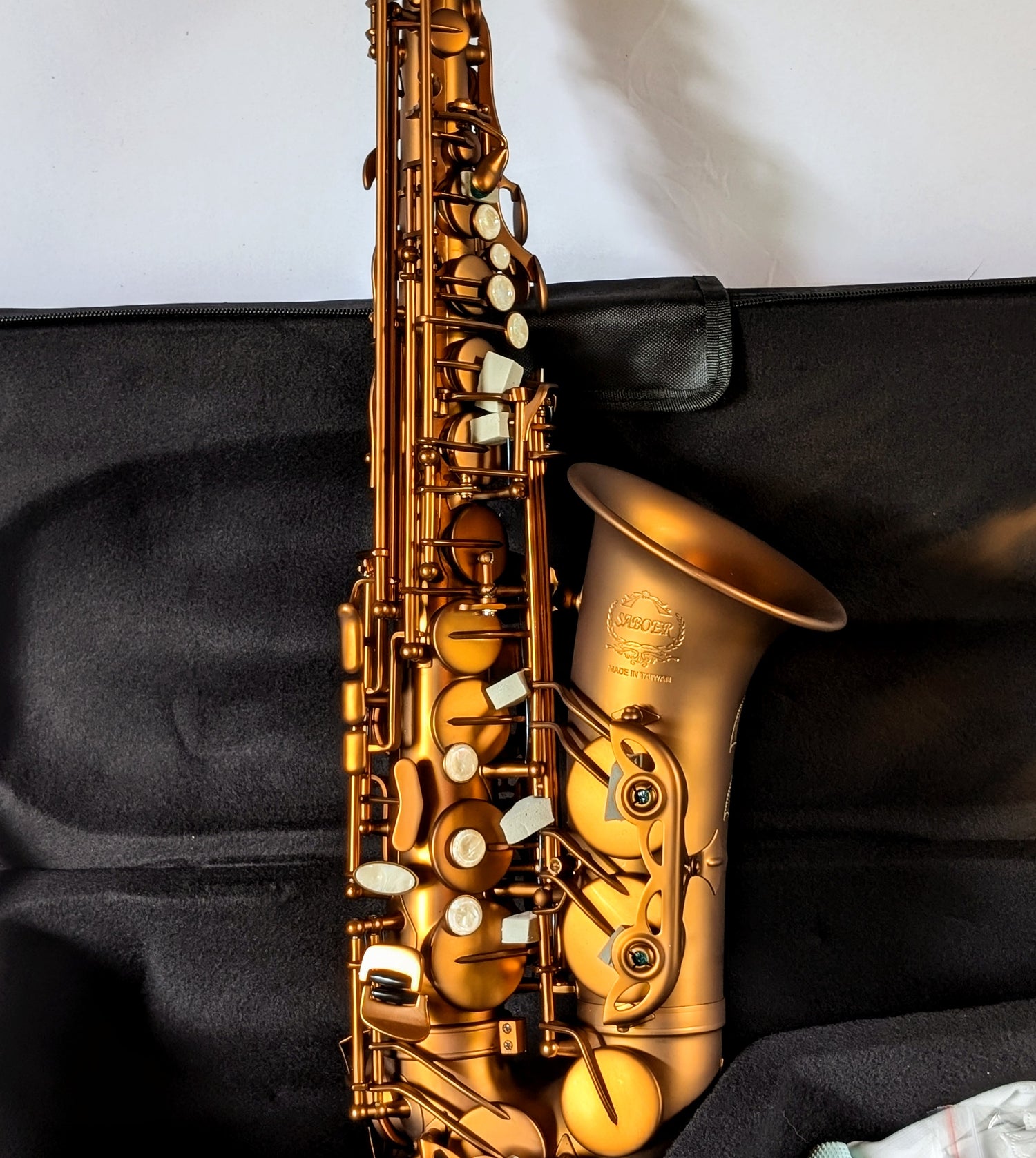 Alto saxophone with distinctive coffee and caramel matte finish, featuring high F# key for student and intermediate players