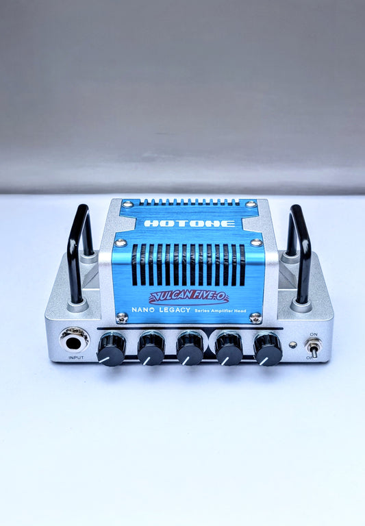 HOTONE Vulcan Hero Nano amp head with blue anodized faceplate, silver aluminum chassis, 5 control knobs for portable guitar amplification