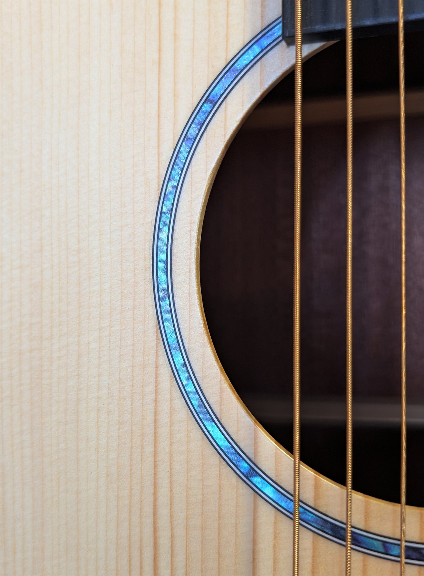 Cirin J. Pickett acoustic guitar with solid wood top, cutaway body design, mother of pearl inlays, and natural wood grain finish