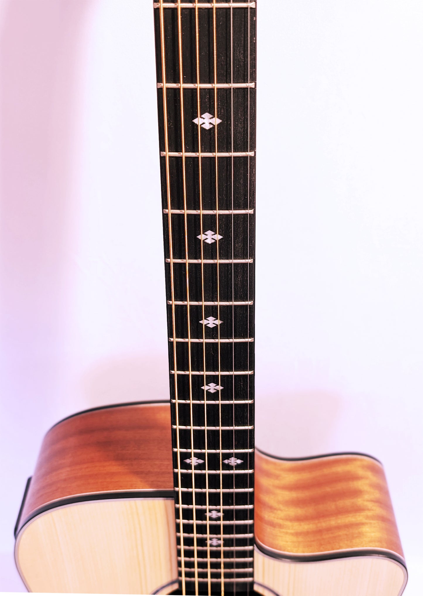 Cirin J. Pickett acoustic guitar with solid wood top, cutaway body design, mother of pearl inlays, and natural wood grain finish