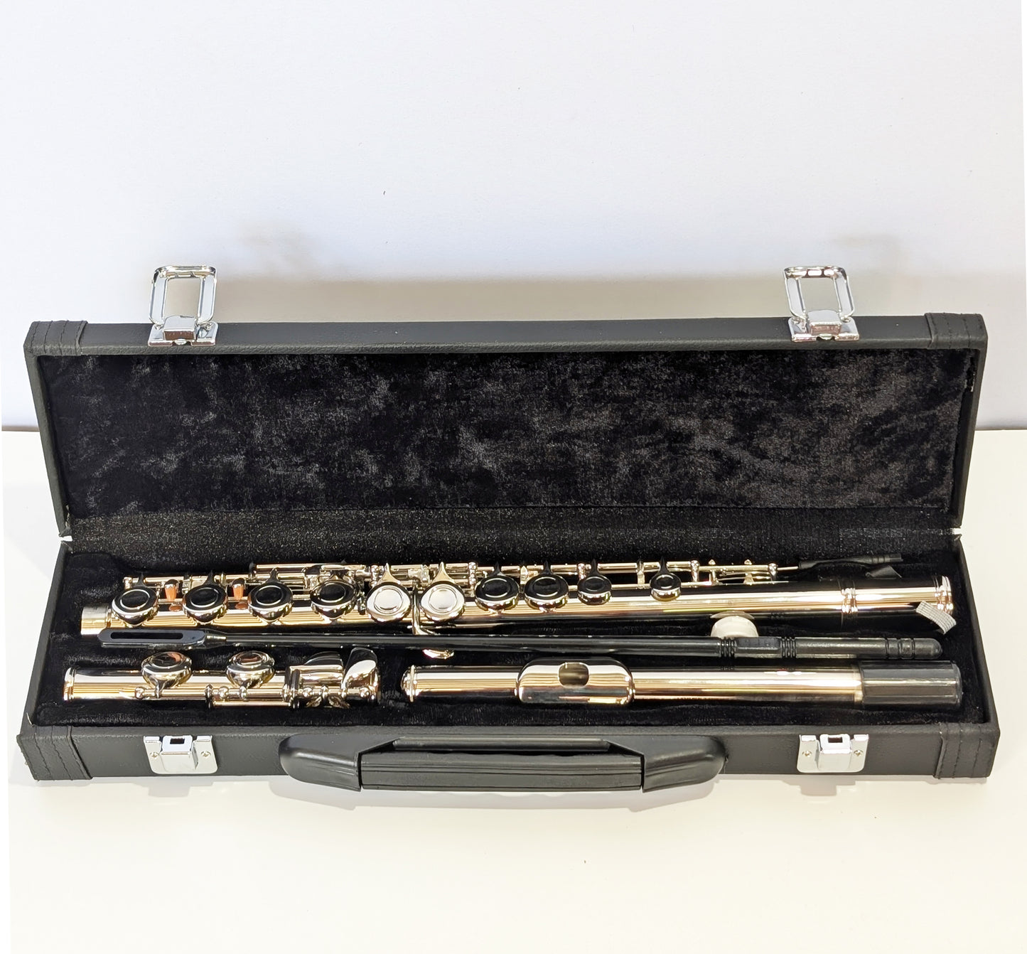 Silver nickel-plated closed hole student flute by PNW Music with precision keys and durable body for beginner flutists