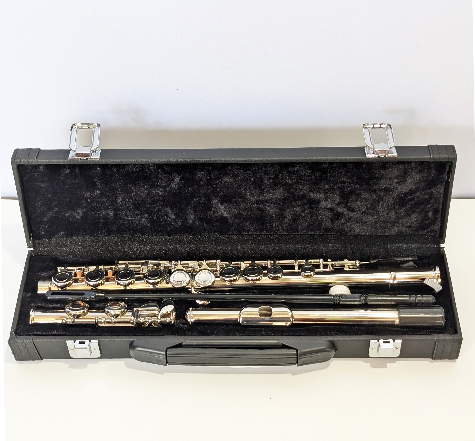 Silver nickel-plated closed hole student flute by PNW Music with precision keys and durable body for beginner flutists