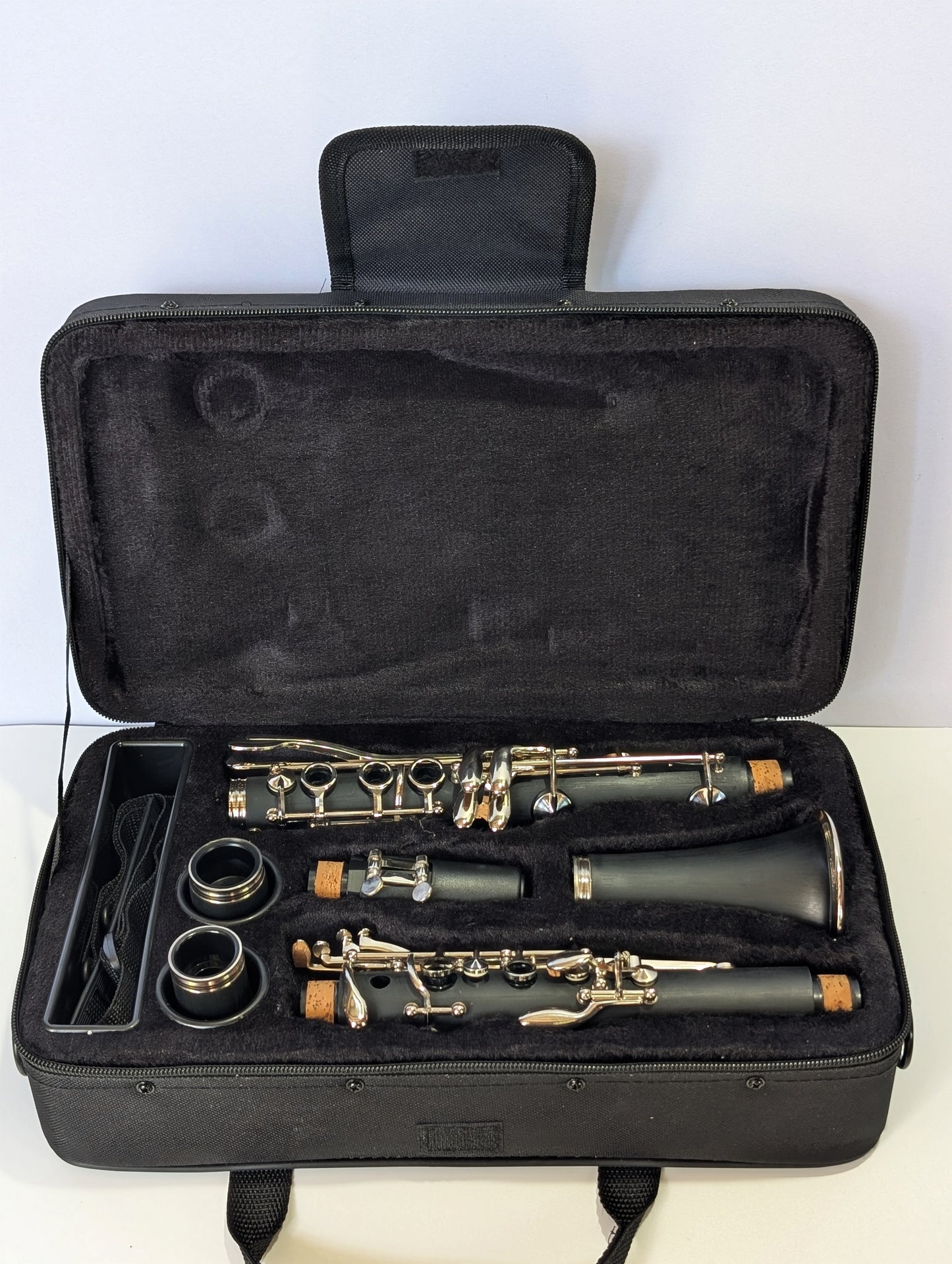 Slade brand student soprano clarinet with black Bakelite body, nickel-plated keys, and dual barrels for intonation flexibility