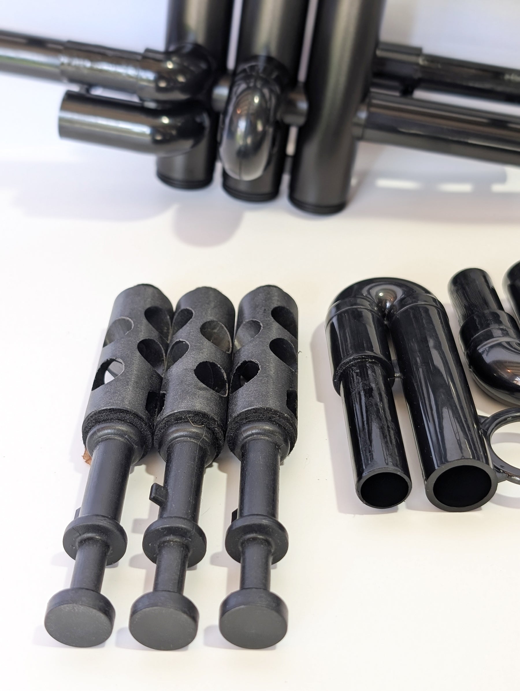 Black plastic trumpet by PNW Music with three valves, designed for students and outdoor use with weather-resistant construction
