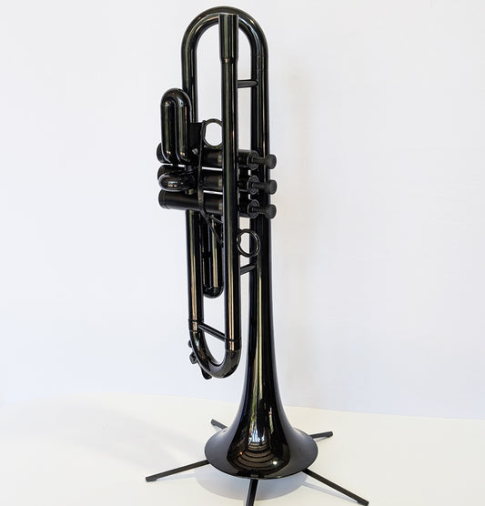 Black plastic trumpet by PNW Music with three valves, designed for students and outdoor use with weather-resistant construction