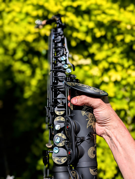 PNW Music matte black alto saxophone with Japanese-inspired finish, featuring high F# key and non-reflective surface for students